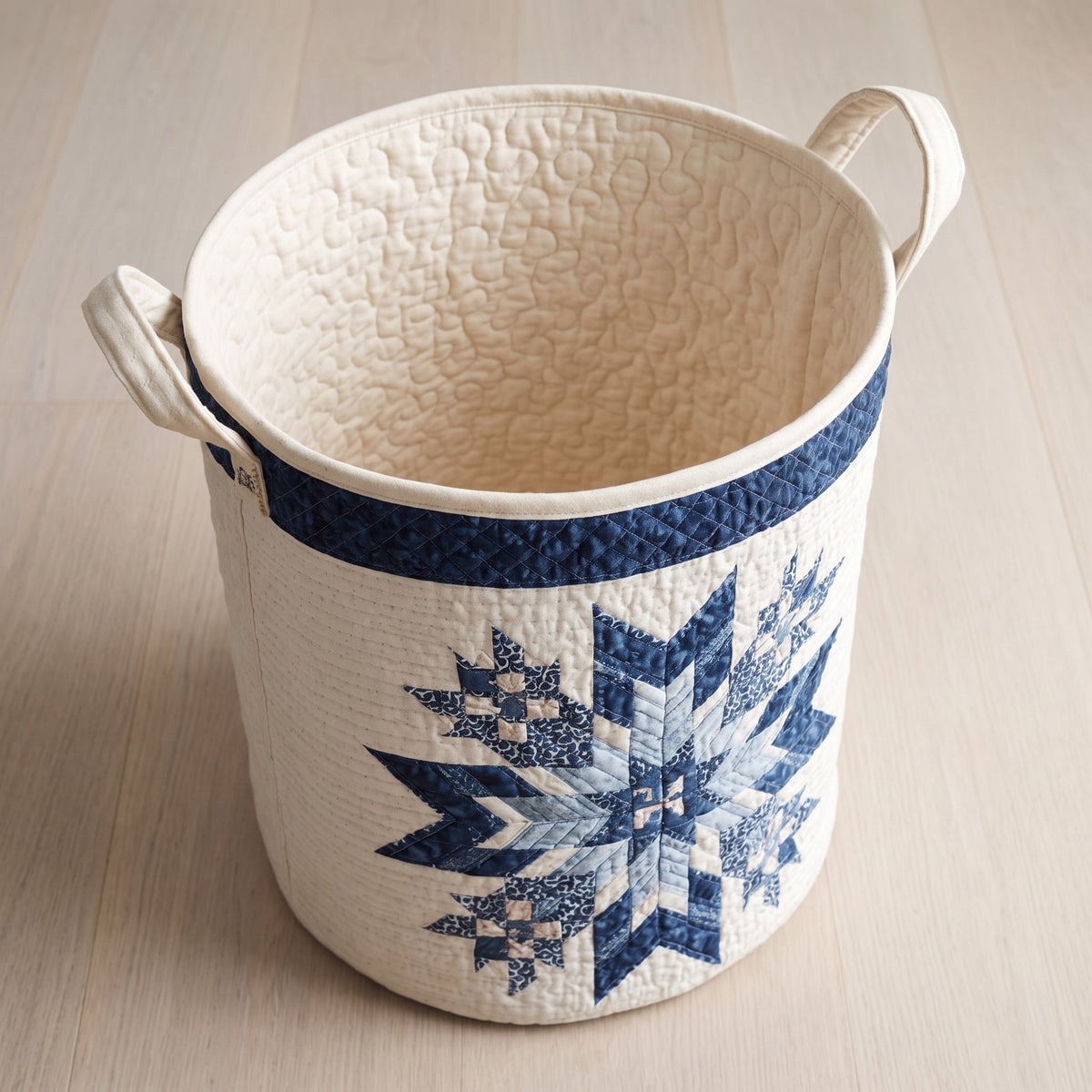 Quilted Laundry Basket - Snowflake — open, showing the plain cream quilted lining