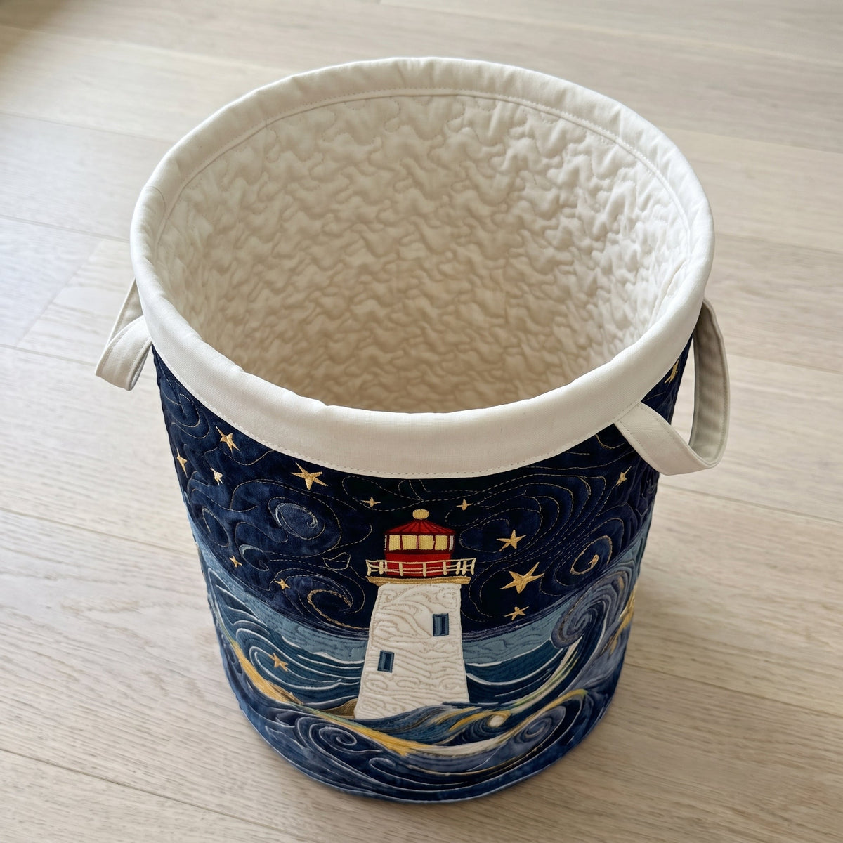 Quilted Laundry Basket - Lighthouse at Dusk — open, showing the plain cream quilted lining