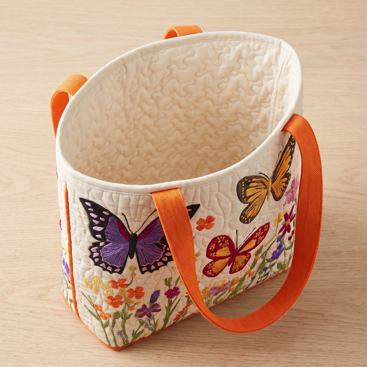Butterfly Flower Garden Quilted Tote Bag — open, showing the plain cream quilted lining