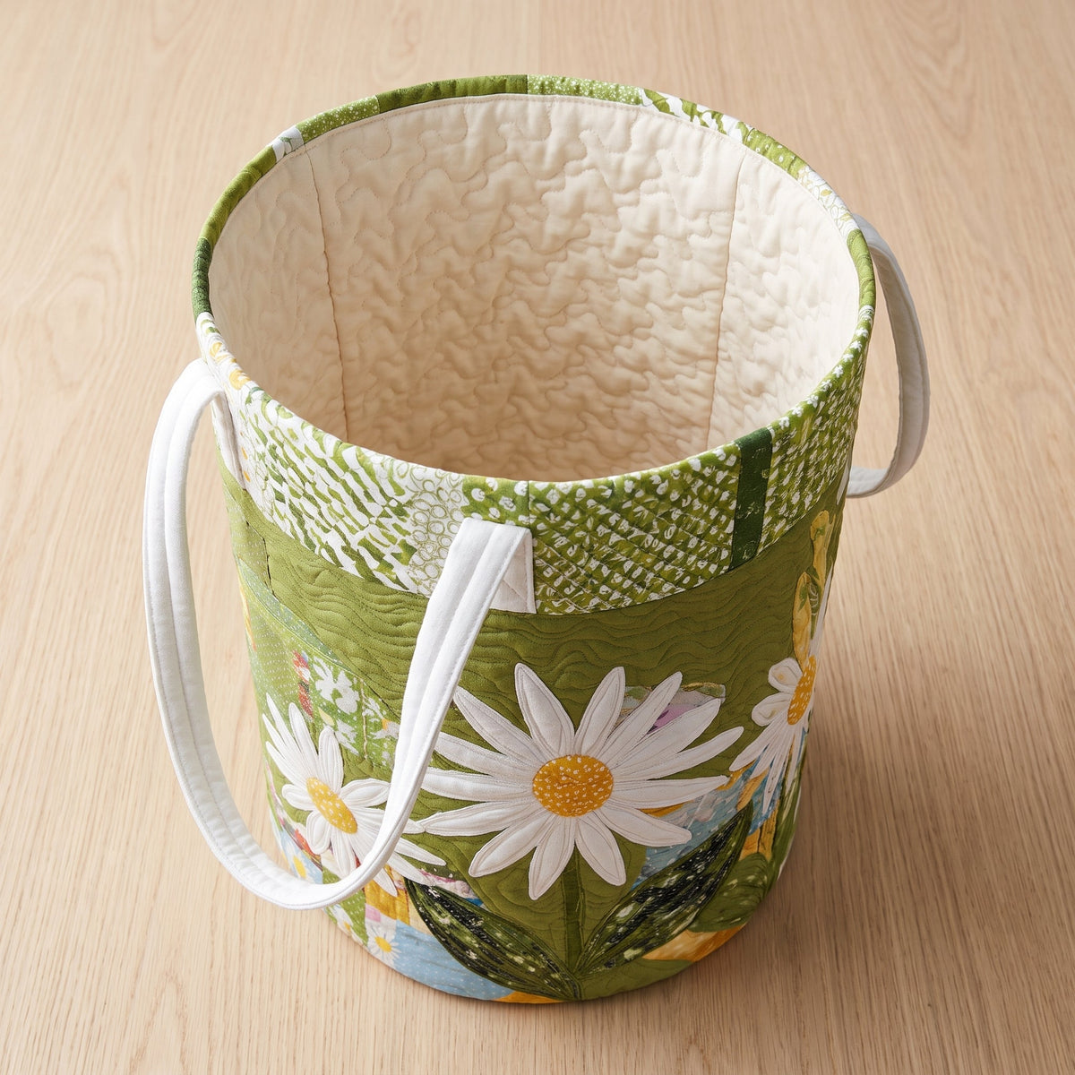 Quilted Laundry Basket - Sunny Stems — open, showing the plain cream quilted lining
