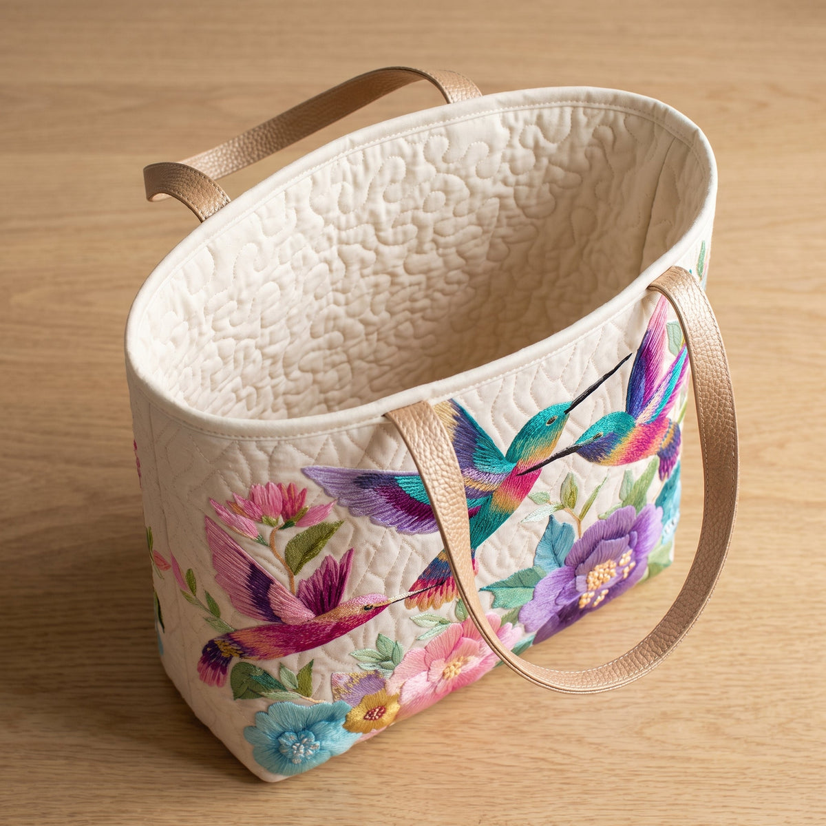 Hummingbird Flower Garden Quilted Tote Bag — open, showing the plain cream quilted lining