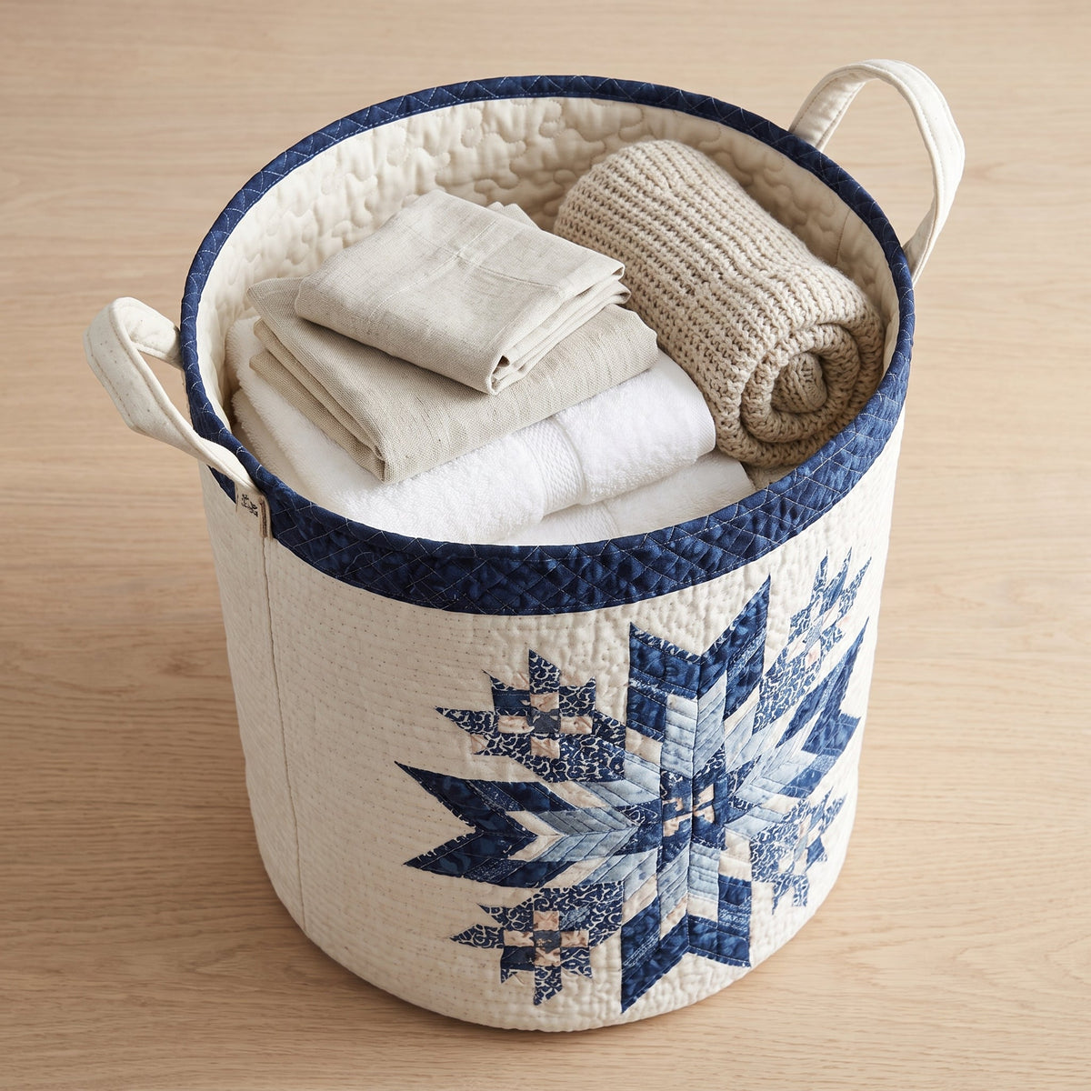 Quilted Laundry Basket - Snowflake — filled with folded towels and laundry
