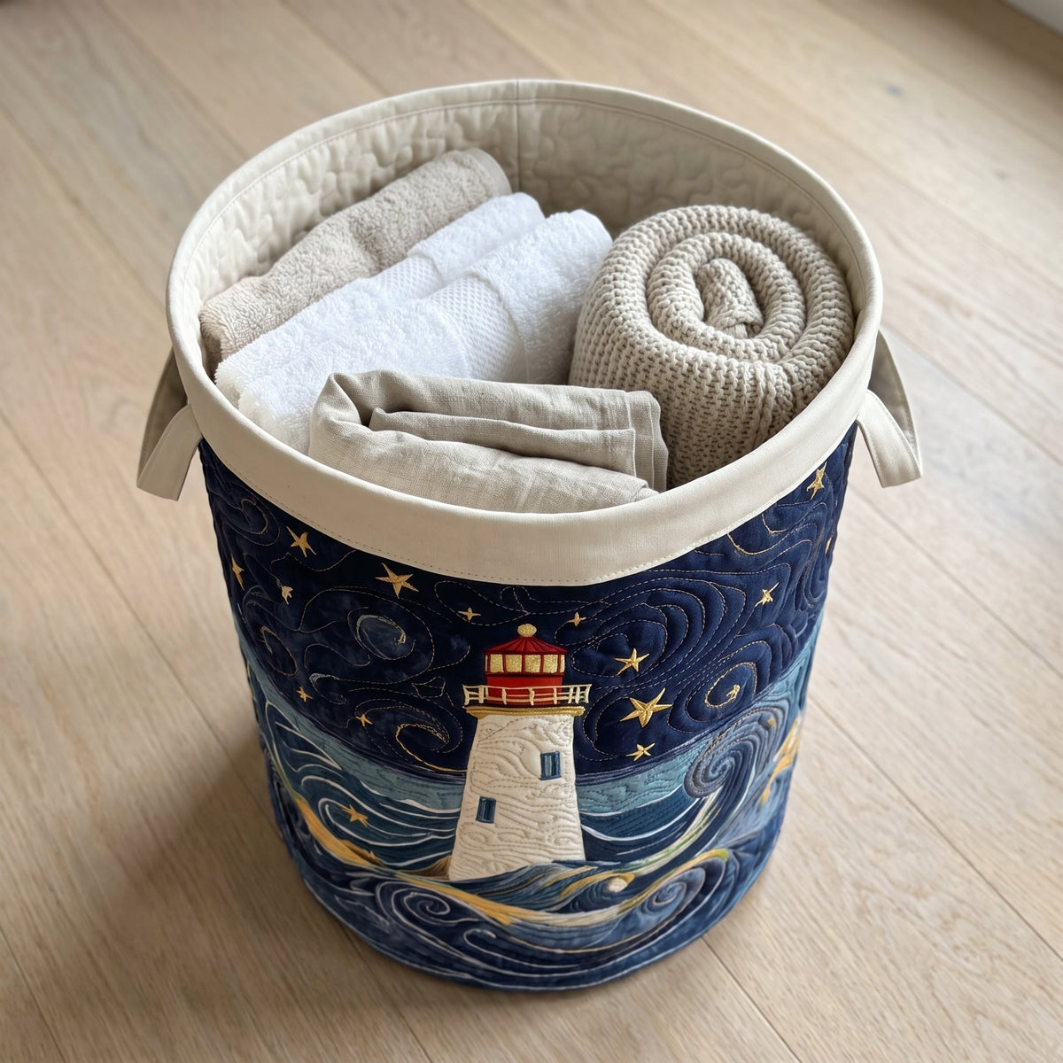 Quilted Laundry Basket - Lighthouse at Dusk — filled with folded towels and laundry